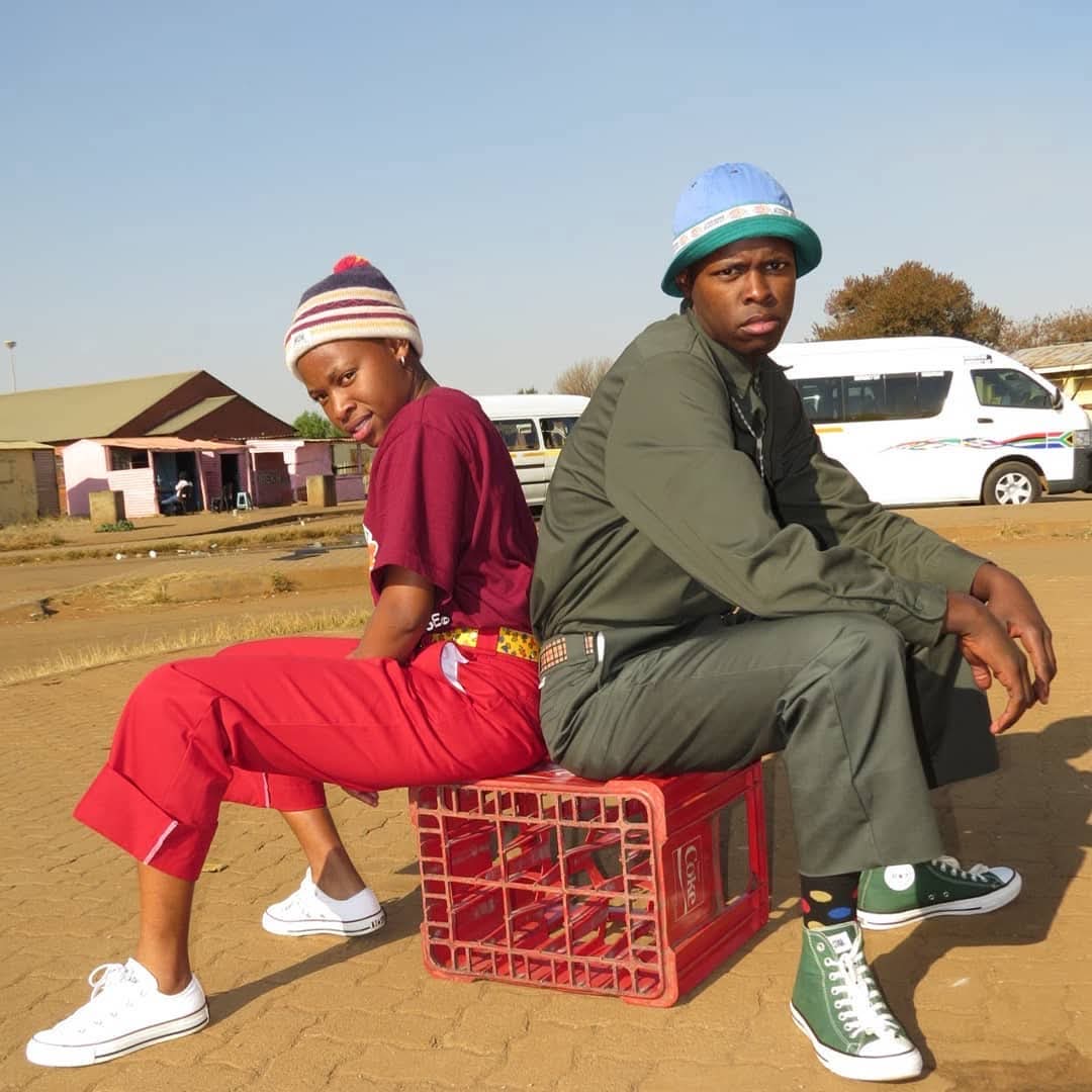 SMP members sitting on a crate