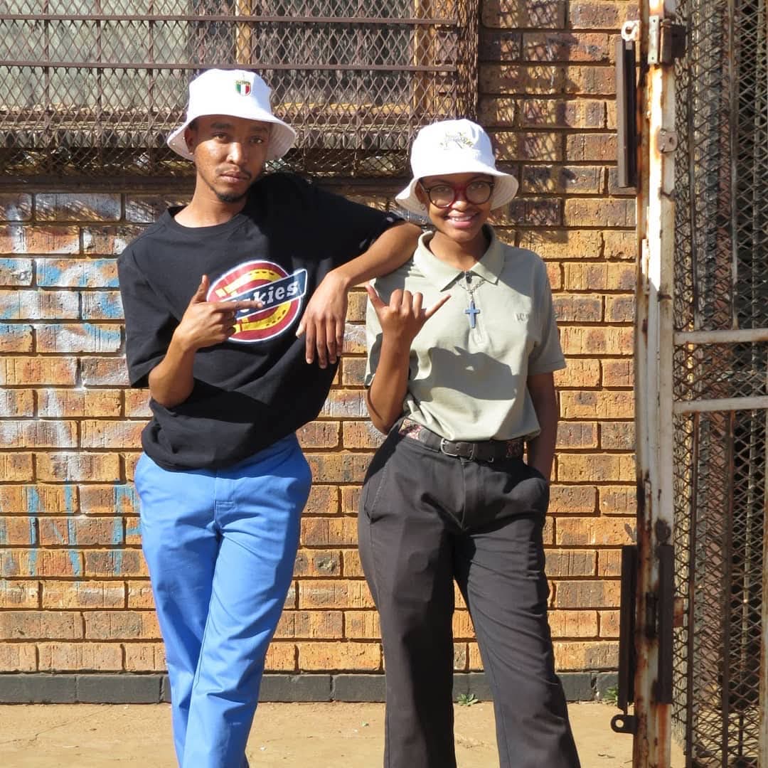 Two SMP members in bucket hats